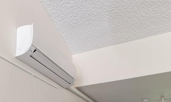 Installatie van een binnen unit van een split airco voor de airconditioning van een kantoor.